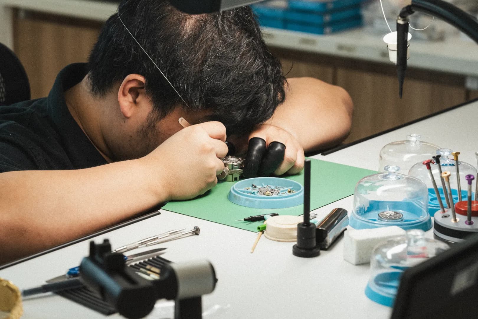 Head Watchmaker inspecting movement components